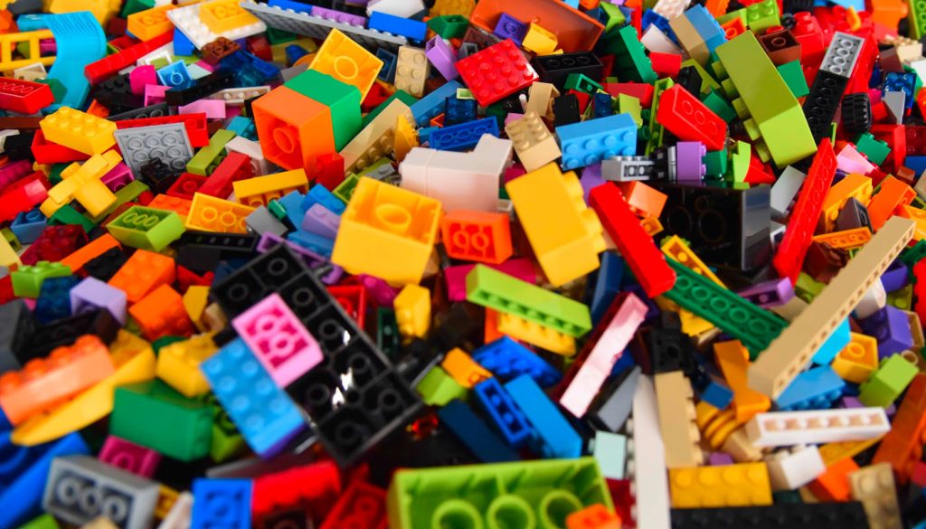 Pile of block toys, mostly LEGOs